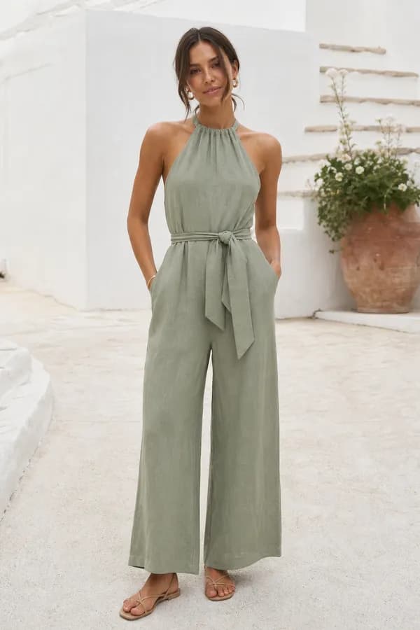 A linen halter-neck jumpsuit with a tie belt and wide legs