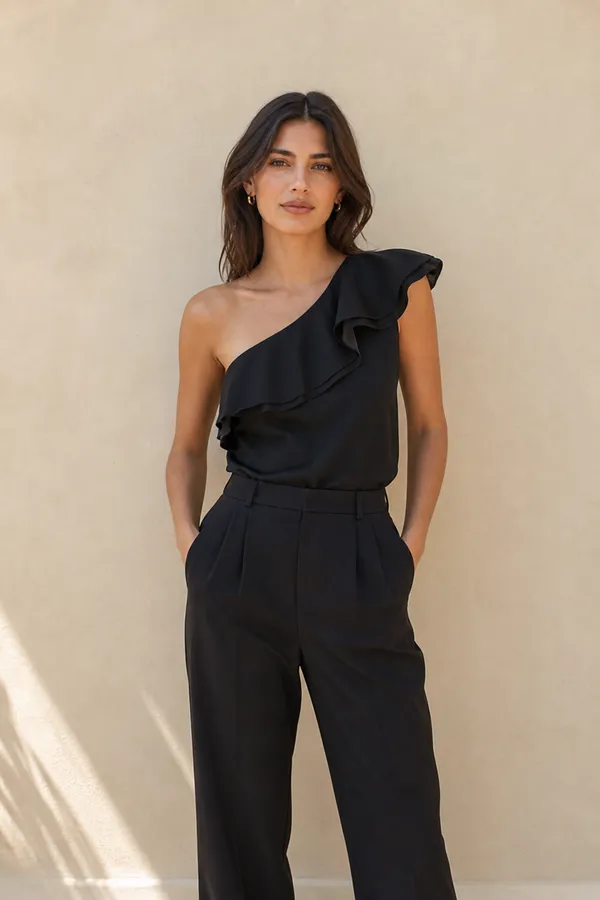 A one-shoulder silk top with a ruffle along the neckline